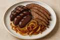 grilled and sliced beef heart along with thinly sliced pan cooked beef liver and sauted onions arranged on a plate
